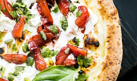 pepperoni pizza with basil leaves