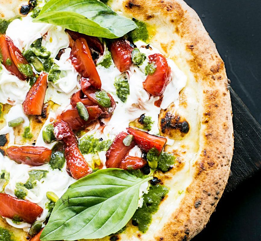 pepperoni pizza with basil leaves